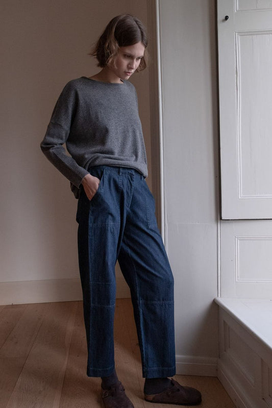 Image of model wearing BIBICO Fair Trade Clothing Margate Relaxed Barrel Leg Trouser in Heavy Indigo Denim. 