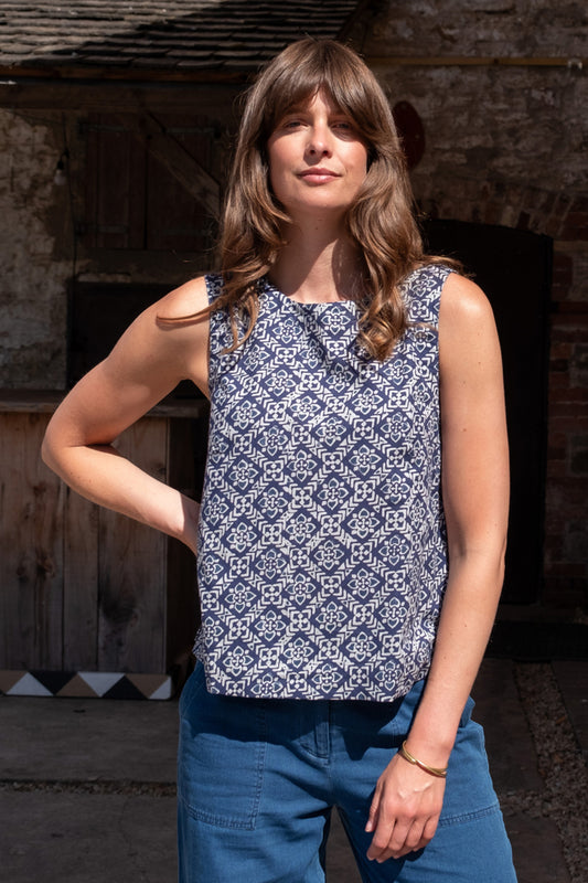Image of model wearing BIBICO Pippa Sleeveless Top in Indigo Block Print. Pippa Top is a crew neck, medium length, sleeveless shell top. Made by Fair Trade Certified Producers using Hand Block Printed Organic Cotton Fabric.