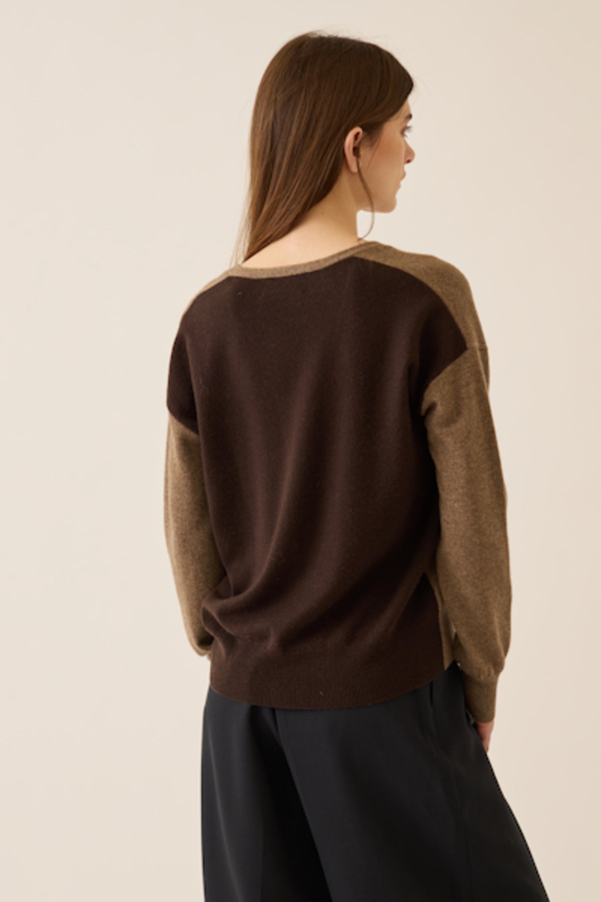 Image of model wearing DEMYLEE Abigail Color Block Cashmere Cardigan in Non-Dye and Espresso Dye Cashmere. 