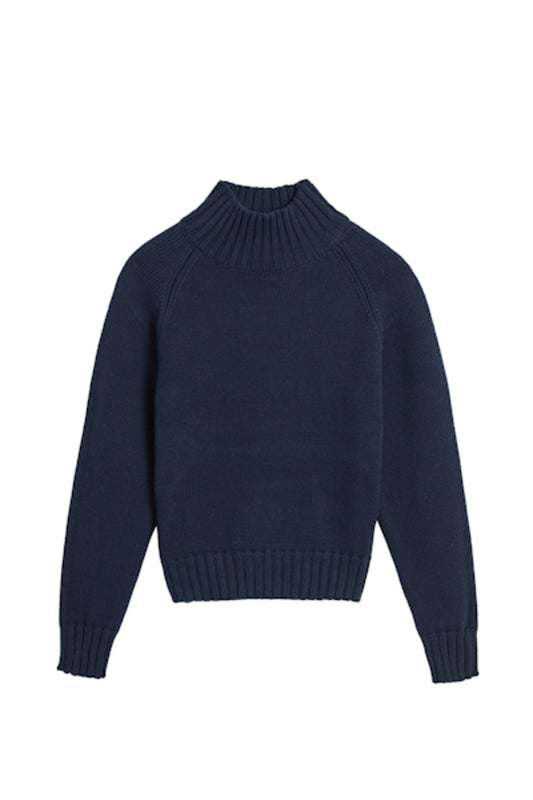 Image of model wearing DEMYLEE Kaitlyn Cotton Cashmere Turtleneck Sweater in Deep Navy. 