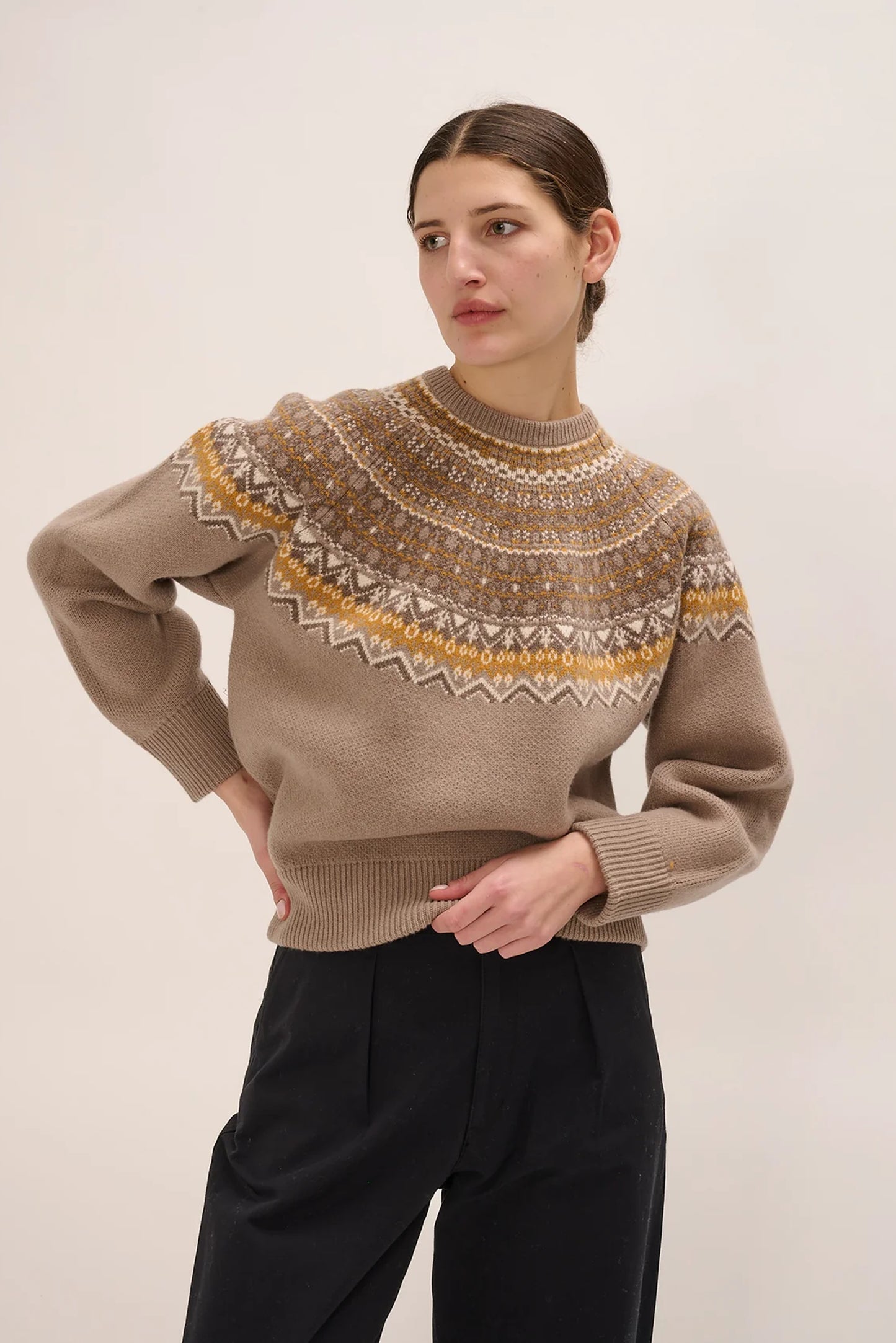 Image of model in Demylee New York Linie Responsible Wool Fairisle Crewneck Sweater featuring a Mustard Yellow and White Fairsile Print on Beige _ Ethical Knitwear Brands _ Women Owned Knitwear Brands