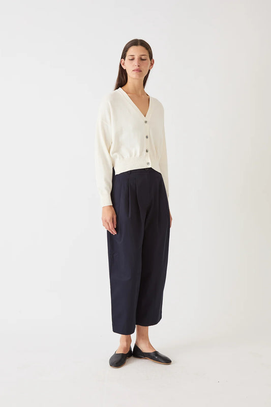 Image of DEMYLEE Lola Cardigan in Natural Off White. Lola Cardigan has a classic, loose fit with an open vneck line and iridescent pearl buttons. Made from cotton-cashmere. 