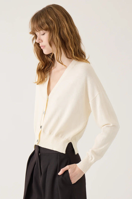 Image of DEMYLEE Lola Cardigan in Natural Off White. Lola Cardigan has a classic, loose fit with an open vneck line and iridescent pearl buttons. Made from cotton-cashmere. 