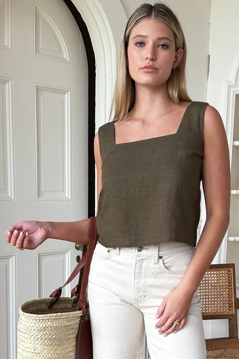 Image of model wearing Emerson Fry Roma 2 Top in Martini Olive Linen. Roma Top is a square neck sleeveless shell top with a slightly cropped length. Made in USA. 