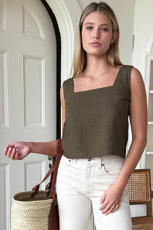 Image of model wearing Emerson Fry Roma 2 Top in Martini Olive Linen. Roma Top is a square neck sleeveless shell top with a slightly cropped length. Made in USA. 