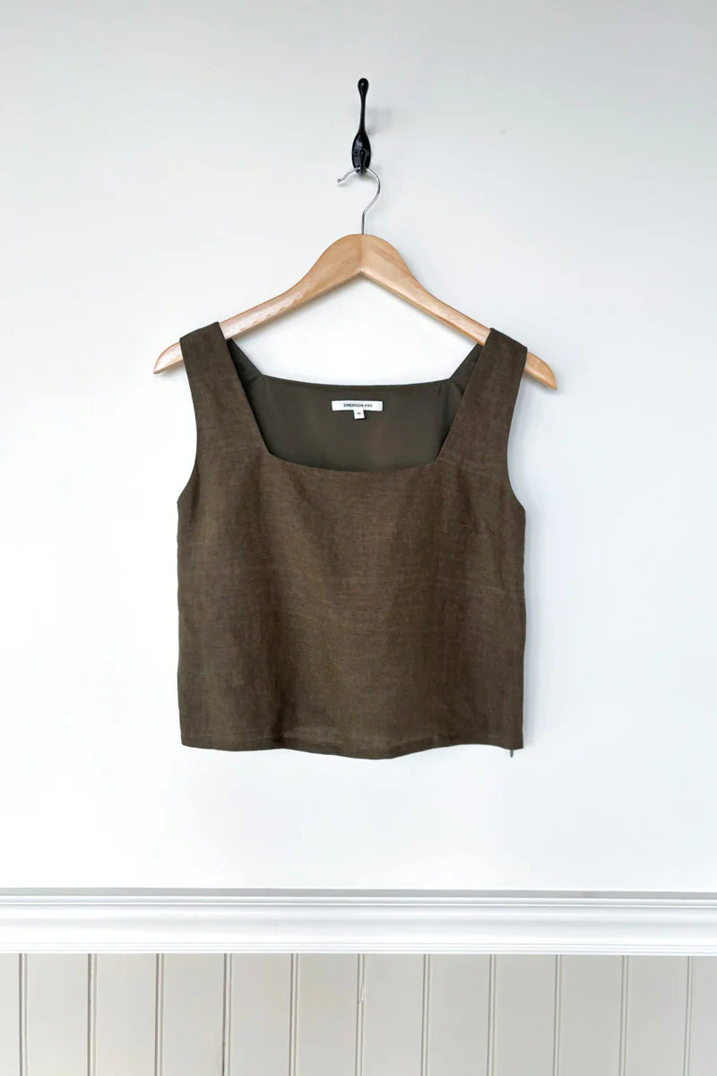 Image of model wearing Emerson Fry Roma 2 Top in Martini Olive Linen. Roma Top is a square neck sleeveless shell top with a slightly cropped length. Made in USA. 