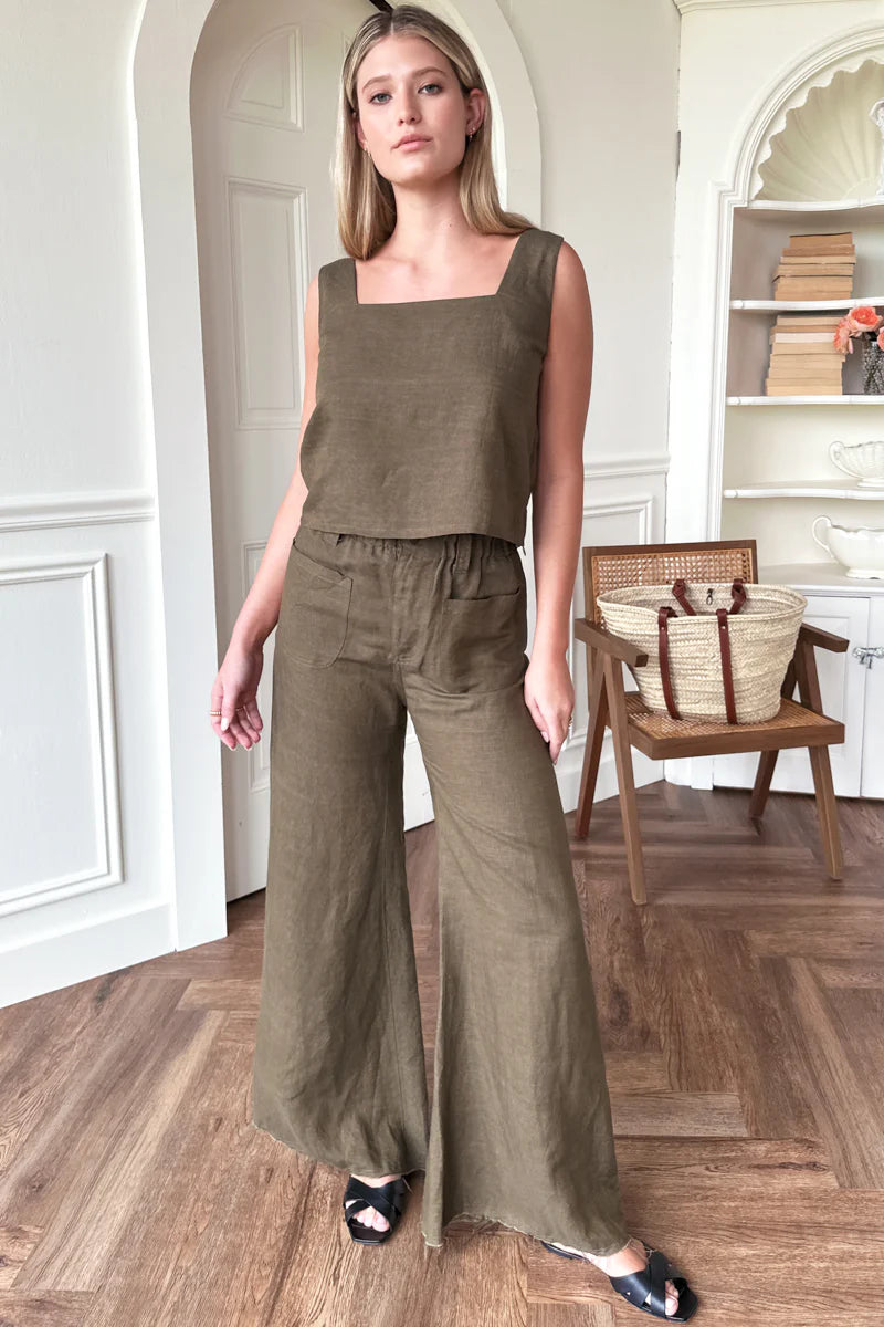 Image of model wearing Emerson Fry Roma 2 Top in Martini Olive Linen. Roma Top is a square neck sleeveless shell top with a slightly cropped length. Made in USA. 