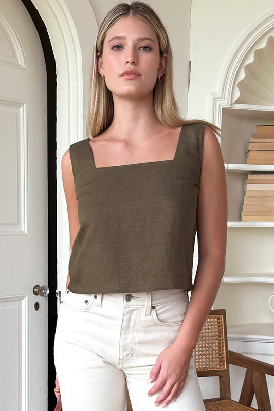 Image of model wearing Emerson Fry Roma 2 Top in Martini Olive Linen. Roma Top is a square neck sleeveless shell top with a slightly cropped length. Made in USA.