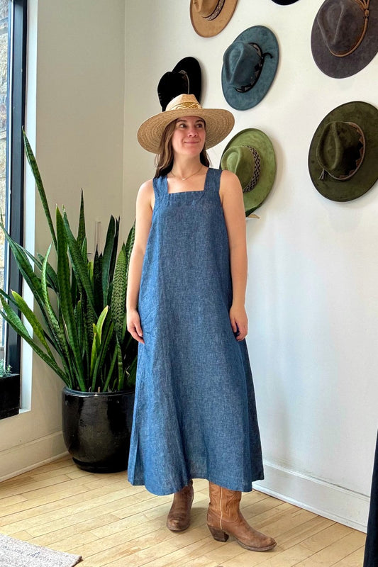 Image of IT IS WELL LA Linen Strap Sundress in Indigo. This dress has a square neckline + back, thick straps, hidden side pockets, and hits midi length. Made in USA. 