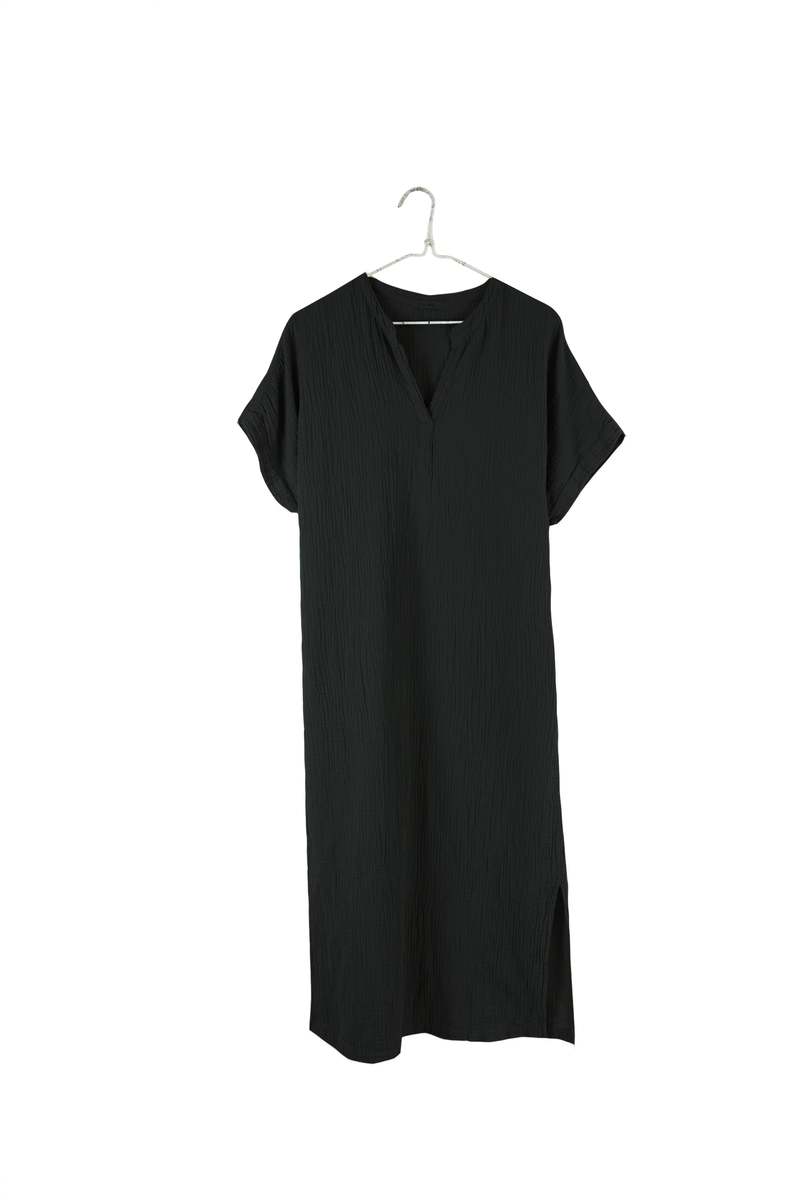Image of IT IS WELL LA Mandarin Gauze Midi Dress in Black. This loose fitting dress is made from an organic cotton crinkled Gauze, hits midi length with symmetrical side slits, rolled short sleeve, and open Mandarin collar. Made in USA. 