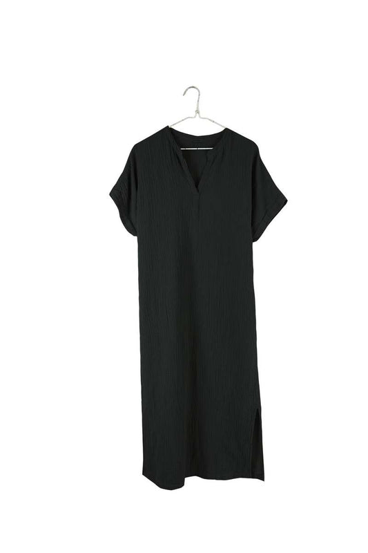 Image of IT IS WELL LA Mandarin Gauze Midi Dress in Black. This loose fitting dress is made from an organic cotton crinkled Gauze, hits midi length with symmetrical side slits, rolled short sleeve, and open Mandarin collar. Made in USA.