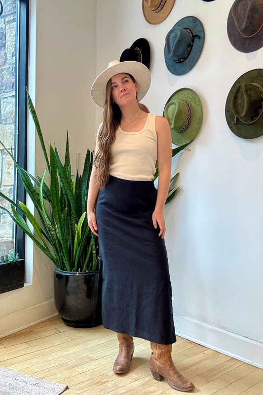 Image of IT IS WELL LA Linen Slit Skirt in Black. This classic, relaxed pencil skirt hits at the ankle with symmetrical side slits. Made in USA.