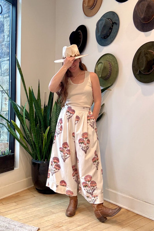 Image of model wearing MAELU DESIGNS Hand Block Printed Fleur Cotton Pant. Fleur Pants are a wide cut, culotte style trouser with a cropped length and all over floral print. 