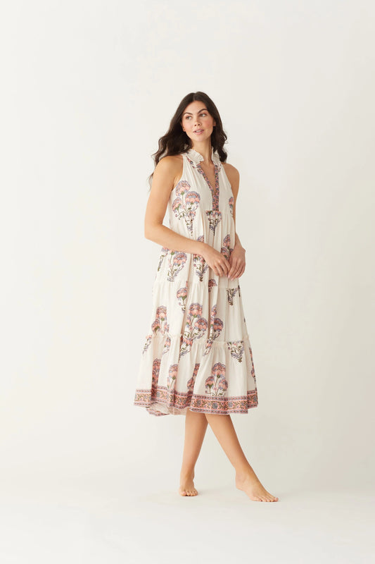Image of model wearing MAELU DESIGNS Poppy Tiered Sundress. Poppy dress is a halter style sundress with flowing, tiered a line skirt, v-neck opening, and frilled bodice in a hand block printed Mischa Floral Cotton. 