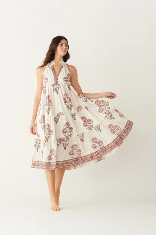 Image of model wearing MAELU DESIGNS Poppy Tiered Sundress. Poppy dress is a halter style sundress with flowing, tiered a line skirt, v-neck opening, and frilled bodice in a hand block printed Mischa Floral Cotton. 