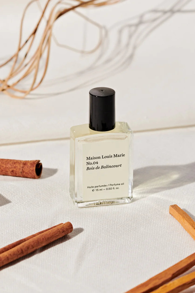 MAISON LOUIS MARIE Roll-On Perfume Fragrance Bottle Shown in Studio with Cinnamon Sticks _ No. 4 Bois des Bailincourt Sandalwood 0.5 fl oz personal perfume oil fragrance