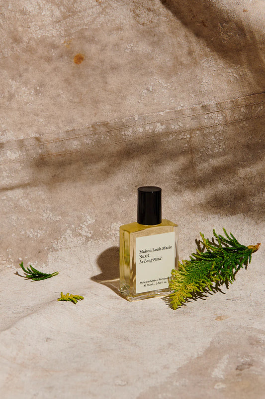MAISON LOUIS MARIE Roll-On Perfume Fragrance shown in studio with Evergreen Spring _ No. 3 Le Long Fond 0.5 fl oz roll-on personal fragrance oil