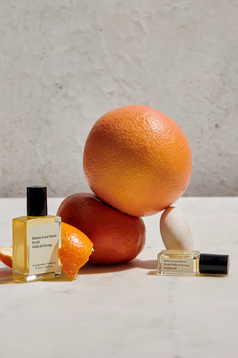 MAISON LOUIS MARIE Roll-On Perfume Oil Bottle in Studio with Orange and Orange Peels _ No. 9 Valley des Farney Citrus & Musk 0.5 fl oz Personal Perfume Oil 