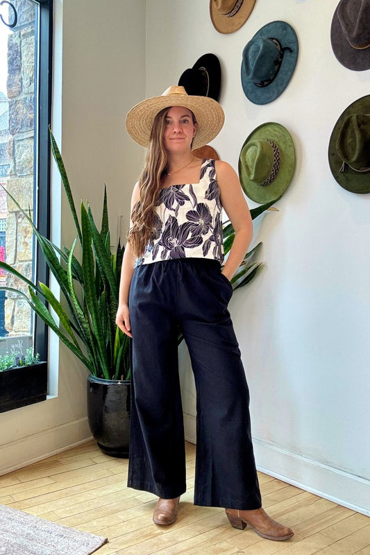 Image of NARY RESORT Koh Rong Lounge Pant in Black Deadstock Linen. These pants have a high rise, frilled drawstring waist, and a full inseam with a wide leg opening. Ethically made in Cambodia.