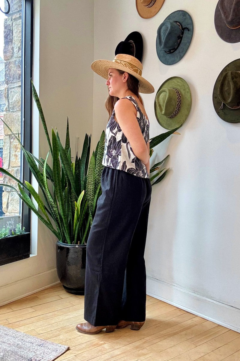 Image of NARY RESORT Koh Rong Lounge Pant in Black Deadstock Linen. These pants have a high rise, frilled drawstring waist, and a full inseam with a wide leg opening. Ethically made in Cambodia. 