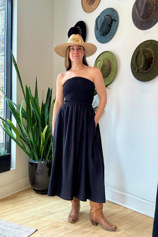 Image of NARY RESORT Shirred Tube Midi Sundress in Black Deadstock linen. This midi length dress has a gathered, pintuck bodice, a-line skirt, and side pockets. Ethically made in Cambodia.