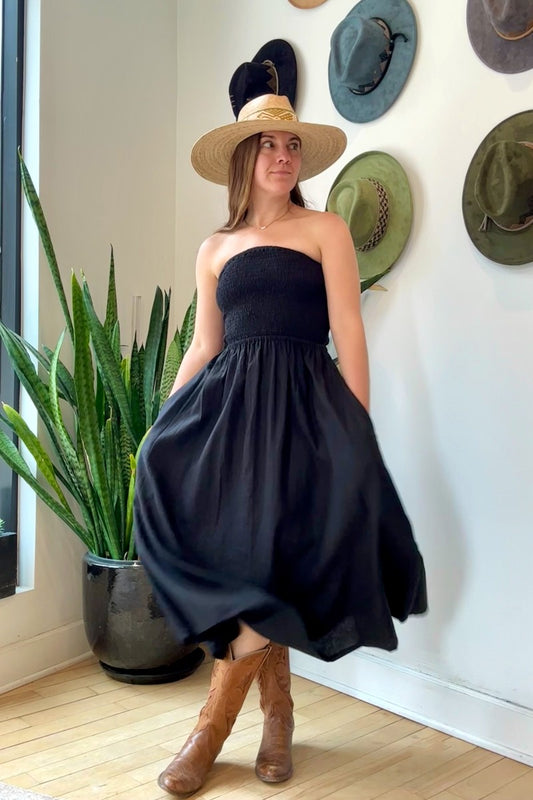 Image of NARY RESORT Shirred Tube Midi Sundress in Black Deadstock linen. This midi length dress has a gathered, pintuck bodice, a-line skirt, and side pockets. Ethically made in Cambodia.