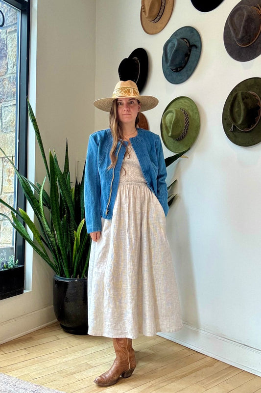 Image of NARY RESORT Shirred Tube Midi Sundress in Grey Stripe Deadstock linen. This midi length dress has a gathered, pintuck bodice, a-line skirt, and side pockets. Ethically made in Cambodia.