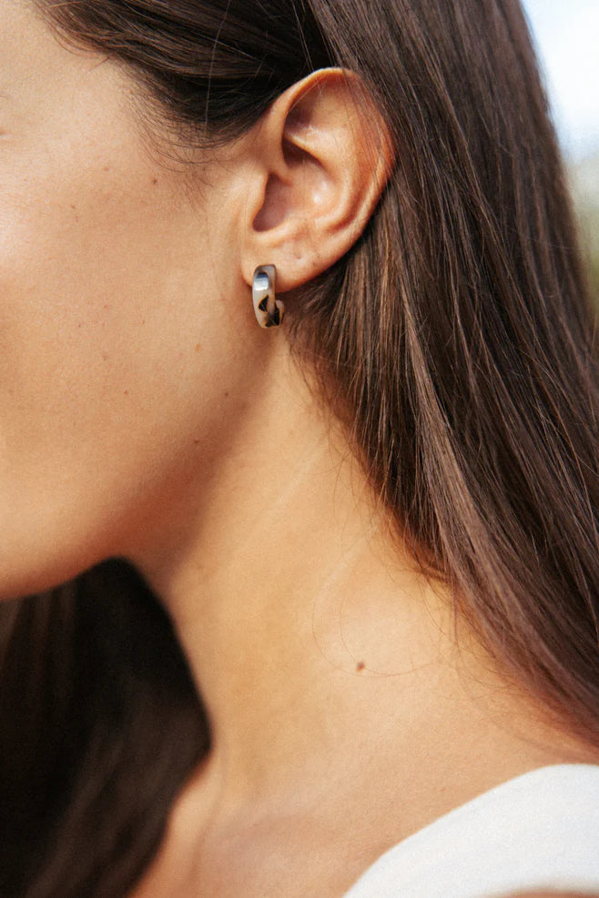 NAT & NOOR Ethically Made Sustainable Jewelry - Nora Mini Huggie Size Hoop Earrings in Pink Brown Tortoise on Model