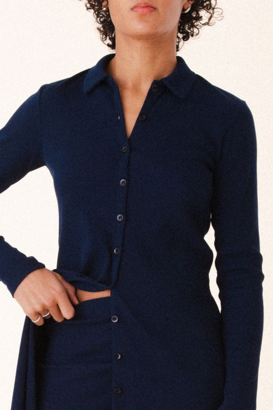 Image of model wearing Cavalos Shirt Dress in Midnight Rib. Cavalos is a fitted shirt dess with a classic collar that hits mid-thigh made from organic cotton Ribbed fabric. 