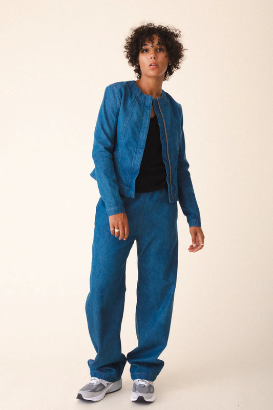 Image of model wearing Prairie Underground Dune Tailored Jean Jacket. Dune Jacket is a tailored collarless jacket with a hidden zip front closure. Designed and produced in Seattle, Washington.
