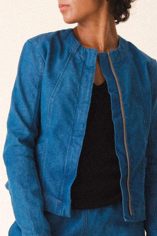 Image of model wearing Prairie Underground Dune Tailored Jean Jacket. Dune Jacket is a tailored collarless jacket with a hidden zip front closure. Designed and produced in Seattle, Washington.