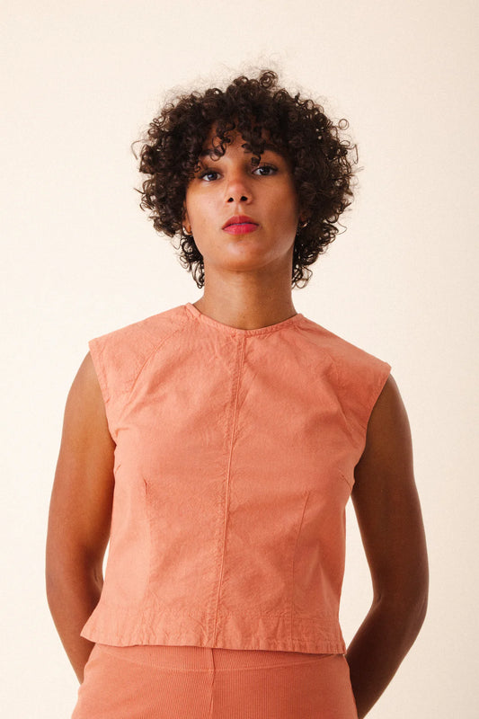 Image of model wearing Prairie Underground Interval Shell Top in Cedar Chest. Interval Top is a tailored sleeveless shell top with tonal darting through, made in Seattle, Washington from a Cedar Pink organic cotton muslin.