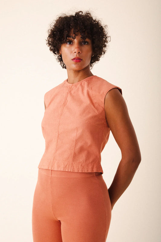 Image of model wearing Prairie Underground Interval Shell Top in Cedar Chest. Interval Top is a tailored sleeveless shell top with tonal darting through, made in Seattle, Washington from a Cedar Pink organic cotton muslin.
