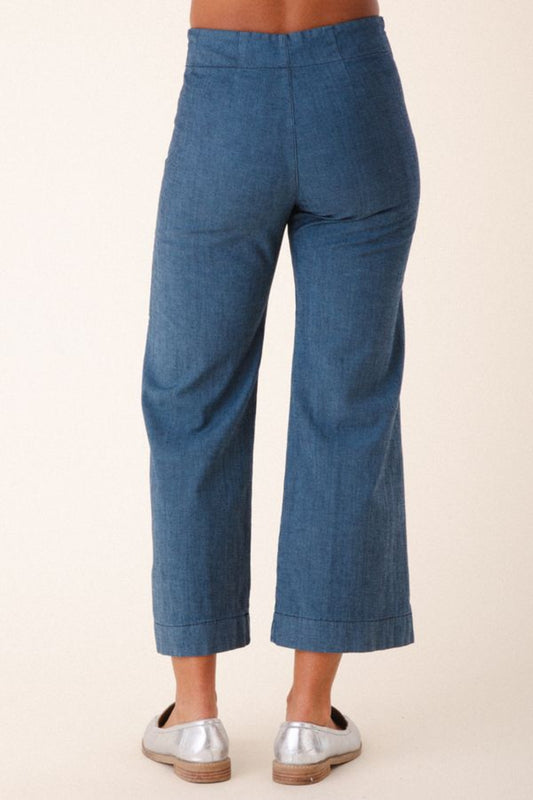 Image of model wearing Prairie Underground Document Jean in Faded Blue. This zip fly Jean has a cropped inseam with a kick flare leg opening. Designed and made in USA. 
