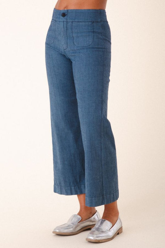 Image of model wearing Prairie Underground Document Jean in Faded Blue. This zip fly Jean has a cropped inseam with a kick flare leg opening. Designed and made in USA. 
