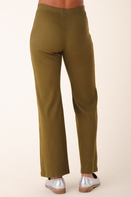 Image of model wearing Prairie Underground Easy Rider Pant in Herb Green Rib. Easy Rider is a mid-rise flared, full length legging made from ribbed organic cotton fabric. Designed and made in USA. 