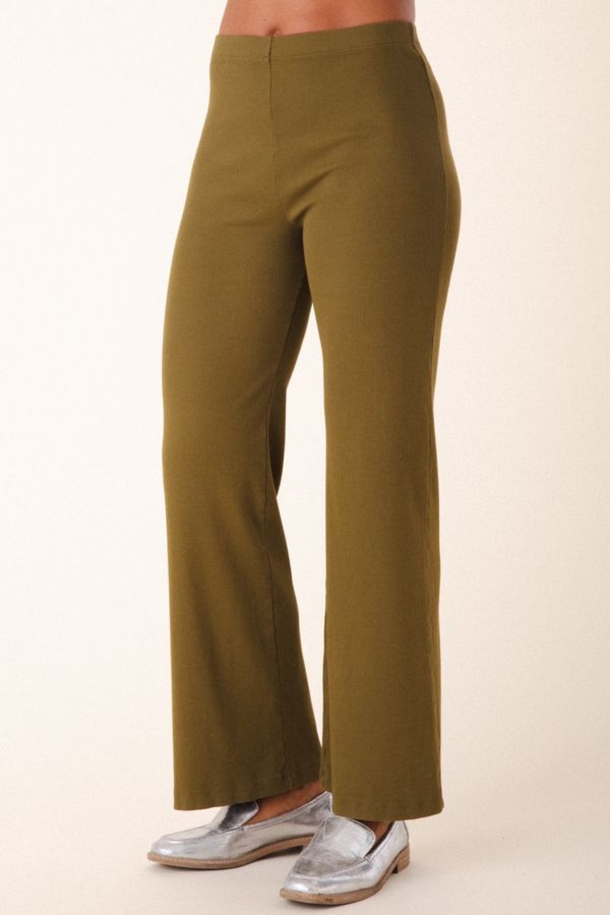 Image of model wearing Prairie Underground Easy Rider Pant in Herb Green Rib. Easy Rider is a mid-rise flared, full length legging made from ribbed organic cotton fabric. Designed and made in USA. 
