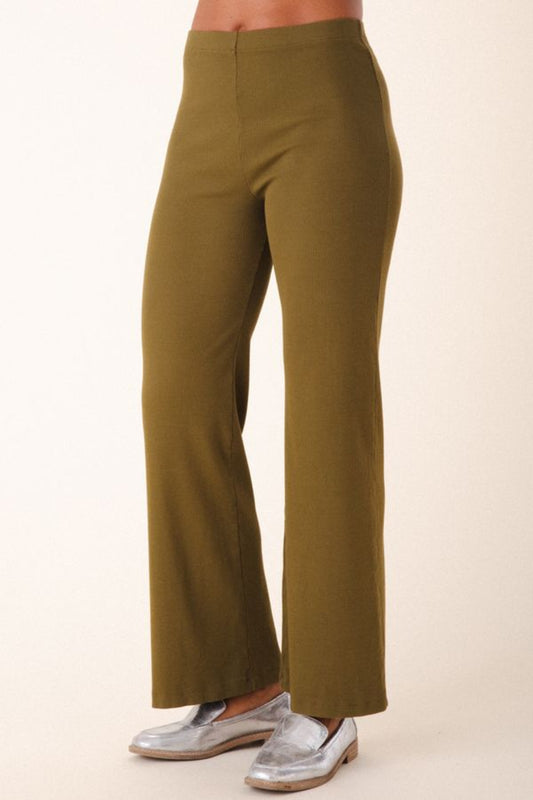 Image of model wearing Prairie Underground Easy Rider Pant in Herb Green Rib. Easy Rider is a mid-rise flared, full length legging made from ribbed organic cotton fabric. Designed and made in USA. 