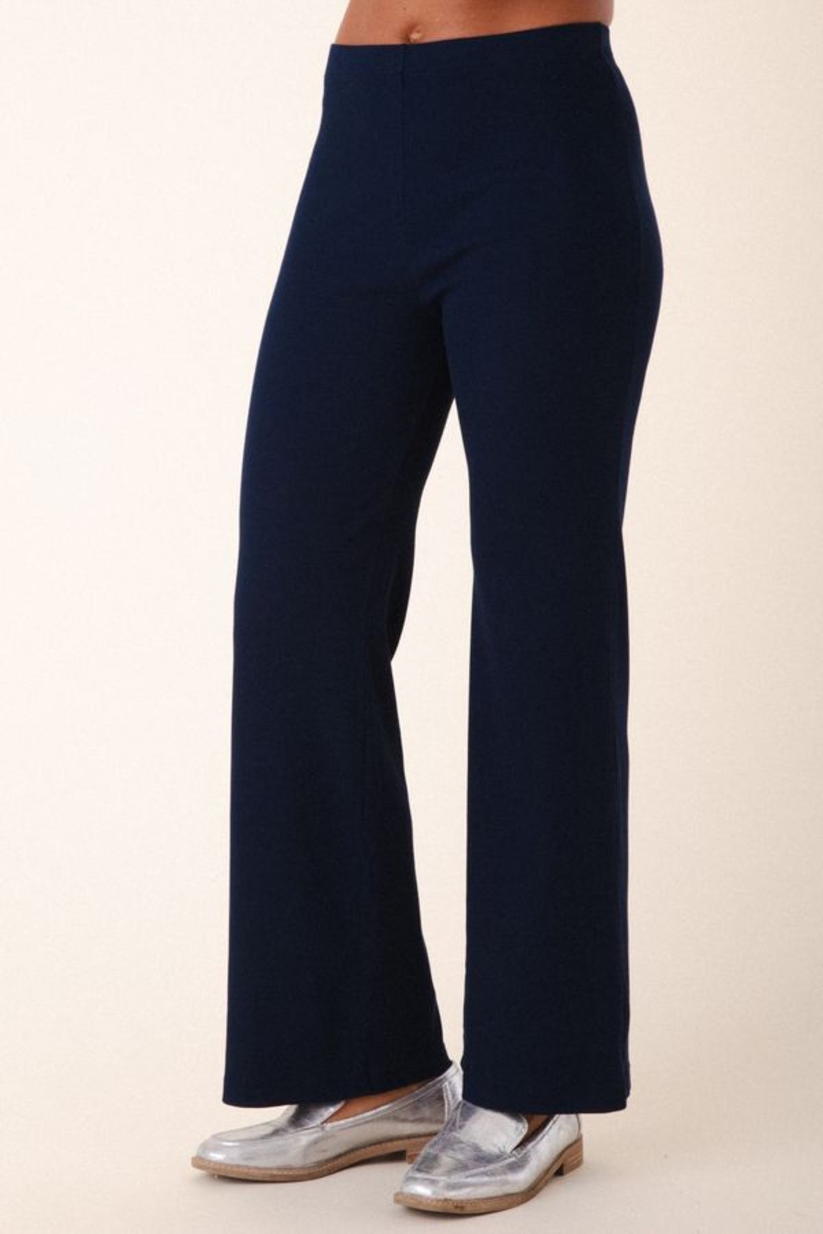 Image of model wearing Prairie Underground Easy Rider Pant in Midnight Rib. Easy Rider is a mid-rise flared, full length legging made from ribbed organic cotton fabric. Designed and made in USA. 