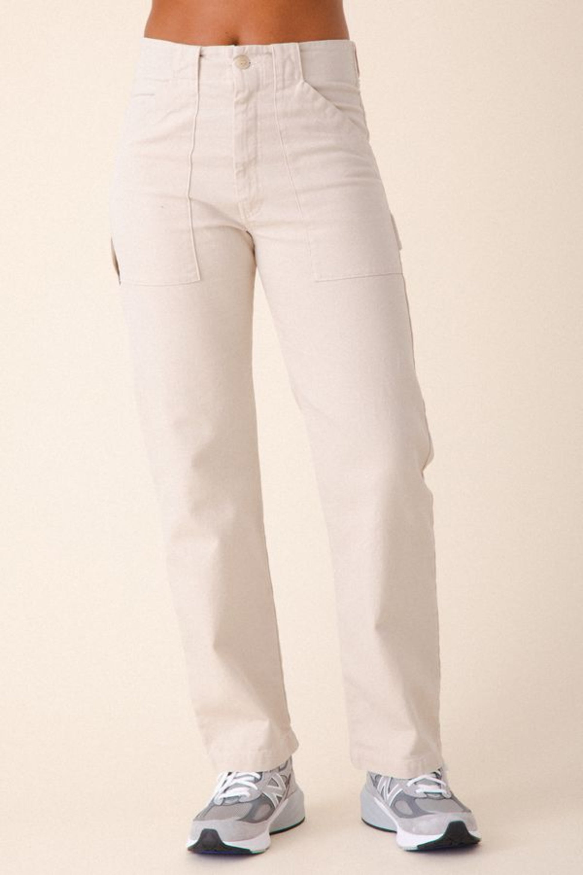 Image of model wearing Prairie Underground Utility Pant in Natural White Organic Cotton Canvas. Utility Pant is a work wear inspired style with a high rise and flattering fit. Designed and produced in Seattle, Washington, USA.