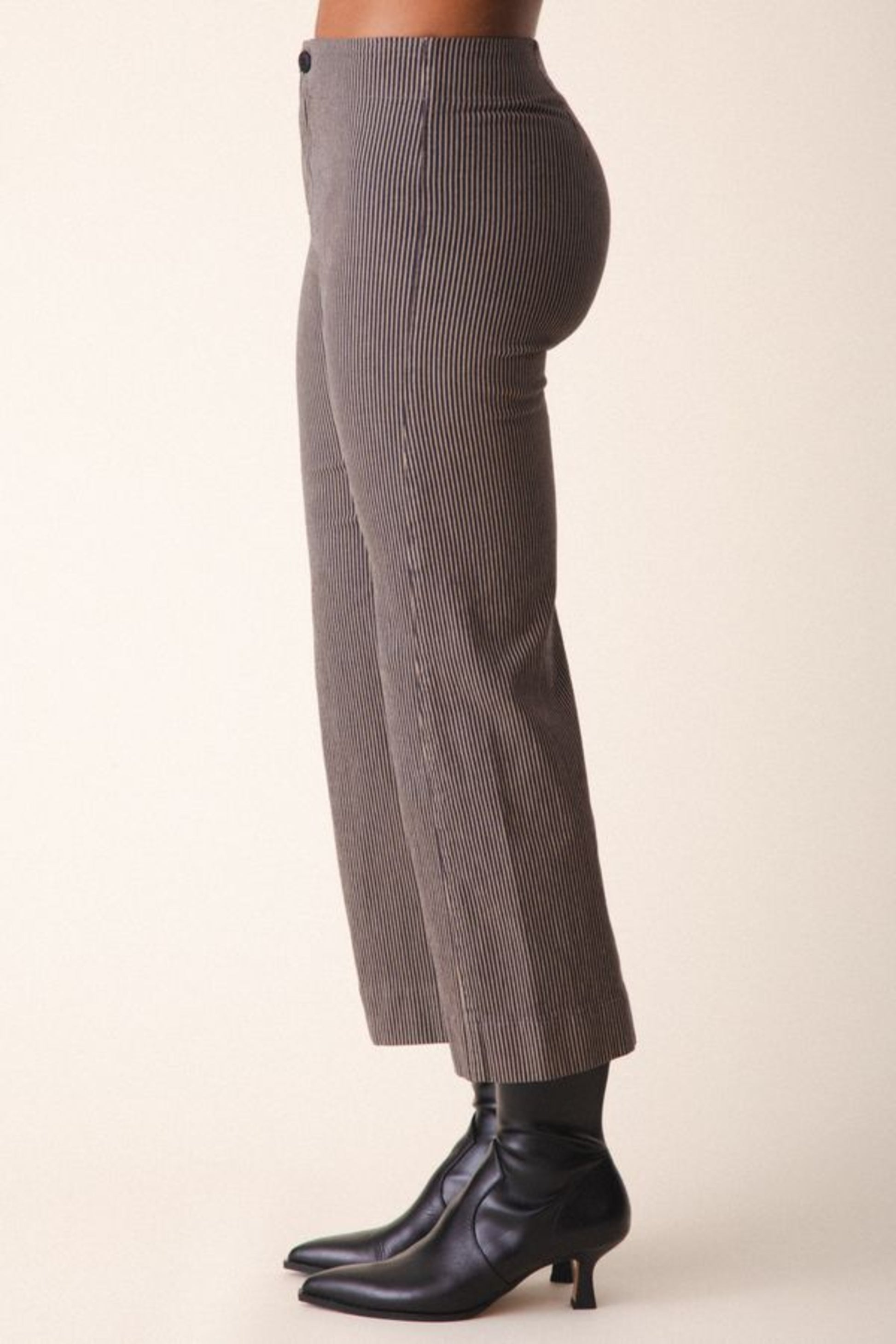 Image of model wearing Prairie Underground Knack Pant in Khaki Railroad Stripe. Knack Pant is a cropped, wide leg, high-stretch pant with flattering darting and zip closure. Designed and produced in Seattle, Washington, USA.