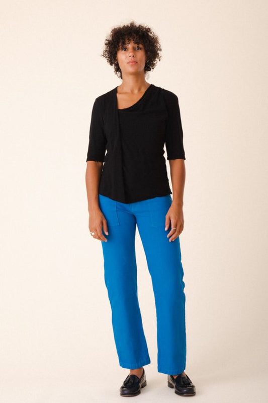 Image of model wearing Prairie Underground Gres Tee in Black. Gres Tee is an elbow length hemp t-shirt with an asymmetrical draped neckline. Designed and produced in Seattle, Washington.