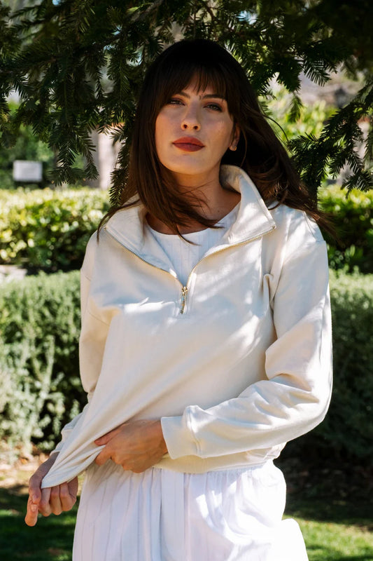 Image of model wearing Whimsy + Row Diana Half Zip Pullover in Cream White. Made in USA from organic cotton fleece.