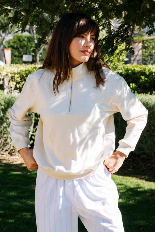 Image of model wearing Whimsy + Row Diana Half Zip Pullover in Cream White. Made in USA from organic cotton fleece.