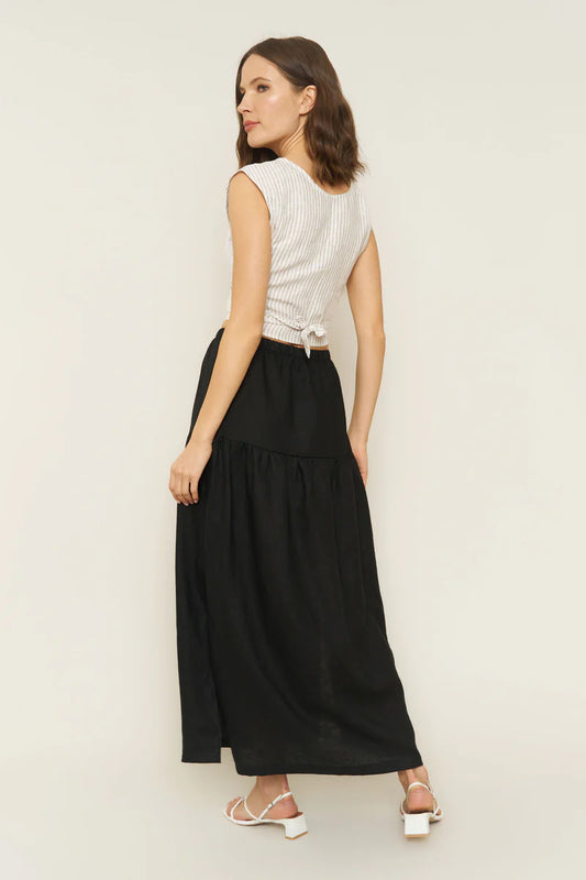 Image of model wearing Millie Convertible Skirt in Black Linen. Millie is a gathered waist Maxi skirt with side slit that can also be worn as a breezy tube dress. Made in USA.