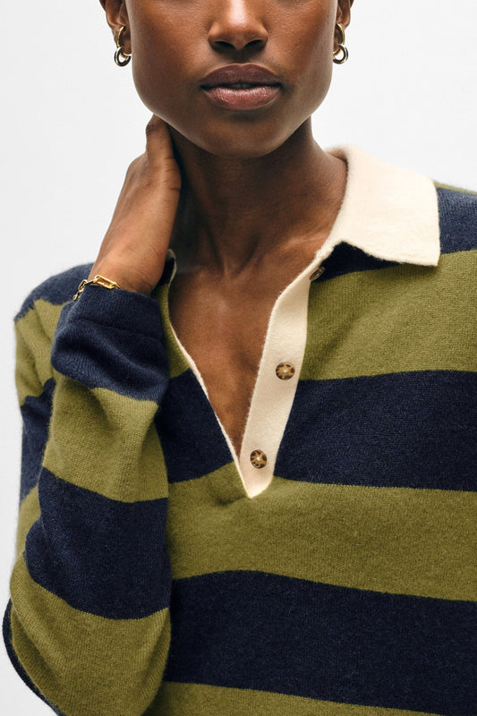 Image of model wearing White + Warren Cashmere Rugby Polo Sweater. This sweater has an oversized fit with all over navy and olive large stripping, contrast cream collar, and tortoise buttons on lapel.
